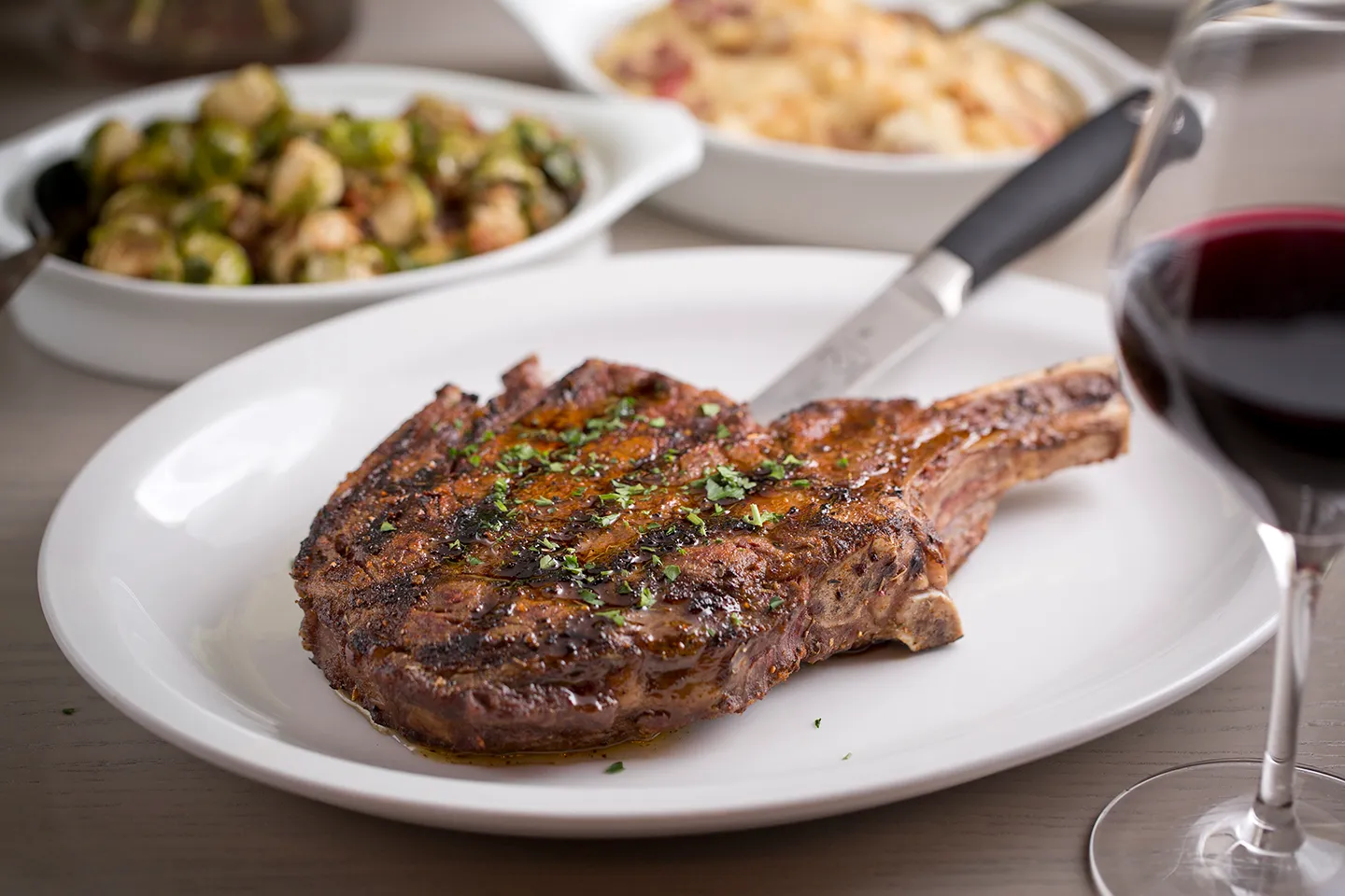 Char ribeye on a plate with sides